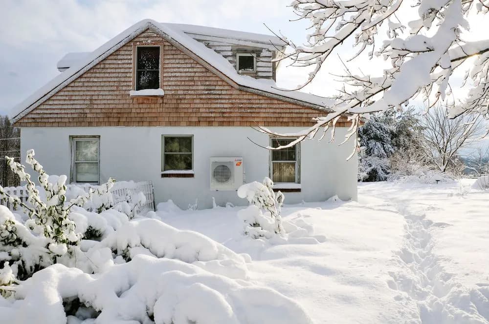 Outdoor heat pump unit operating in winter snow